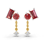 A pair of gold and white gold drop earrings featuring a large baguette-cut red gemstone, a round red gemstone, a small gold chain, and a dangling clear gemstone, shown on a white background.