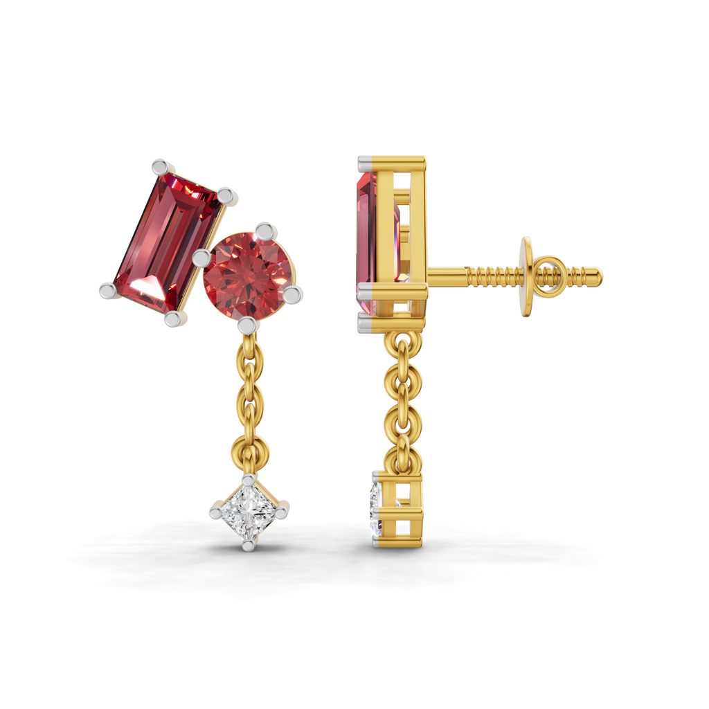 A pair of gold drop earrings with a rectangular red gemstone, a round red gemstone, a small gold chain, and a diamond pendant, shown on a white background.