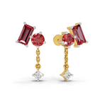 A pair of gold and white gold drop earrings featuring a rectangular red gemstone, a round red gemstone, a short gold chain, and a dangling clear diamond-cut gemstone, shown on a white background.
