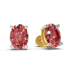 A pair of oval-cut red gemstone stud earrings in four-prong settings, one shown from the front and the other from the side/back. The front earring features a silver-toned setting, while the side earring shows a gold-toned post and backing.