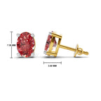 Oval red gemstone stud earrings shown on a white background, with one earring facing forward and the other in side profile showing the post and backing. Black measurement lines indicate 7.