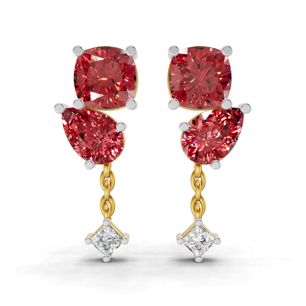 A pair of gold and white gold drop earrings featuring three red gemstones and a small clear diamond at the bottom, set against a plain white background.