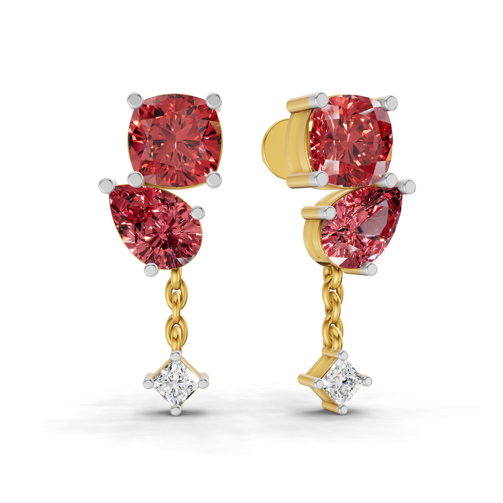 A pair of gold and white gold drop earrings featuring large pinkish-red round and marquise-cut gemstones, with a small clear diamond hanging at the bottom of each earring, shown on a white background.