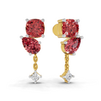 A pair of gold and white gold drop earrings featuring large pinkish-red round and marquise-cut gemstones, with a small clear diamond hanging at the bottom of each earring, shown on a white background.