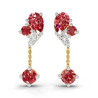A pair of gold and white gold drop earrings featuring oval-cut red diamonds, round-cut red diamonds, and small clear accent diamonds, shown on a white background.