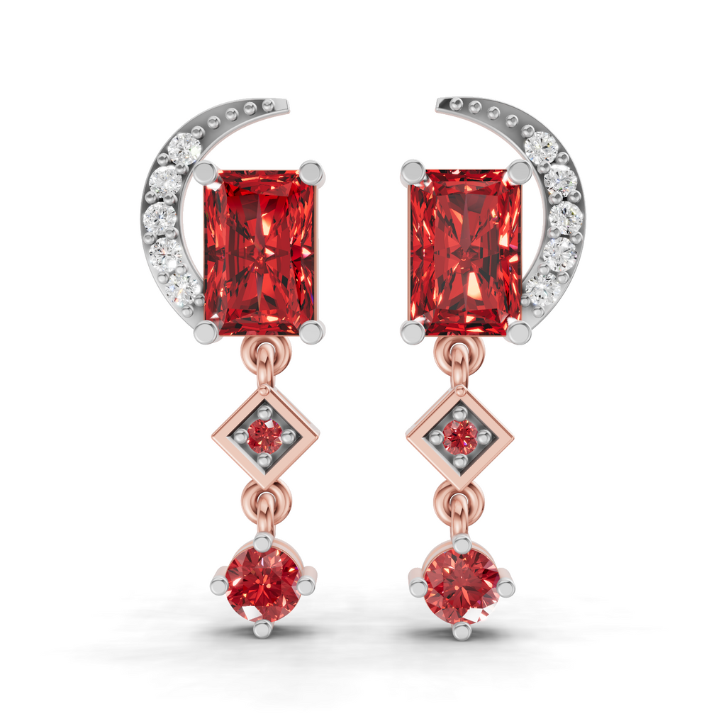 A pair of rose gold and white gold drop earrings featuring rectangular red gemstones, a crescent moon with small clear stones, and diamond-shaped accents on a white background.