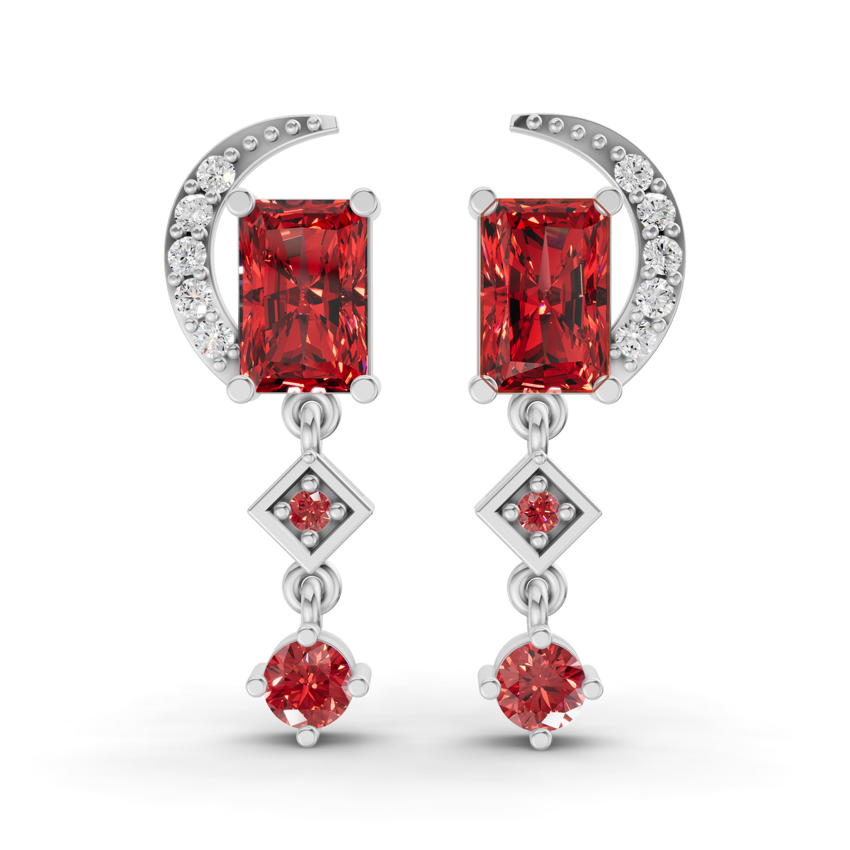 A pair of silver drop earrings featuring rectangular red gemstones, a crescent moon with small clear stones, and diamond-shaped drops with smaller red gemstones, shown on a white background.