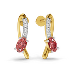 A pair of gold huggie hoop earrings with a curved design, featuring a large oval pinkish-red center stone and a channel-set row of clear cubic zirconia stones on a silver-tone inner band, shown on a white background.
