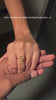 A close-up shot shows a hand resting atop another person's hand, displaying a gold ring with a three-leaf clover or flower design set with sparkling stones, accompanied by text reading "PoV : Flowers may wither but SparQ will never...🫶".   